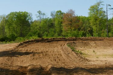 Breaking bumps at the entrance to the sweeper at Martin MX Park